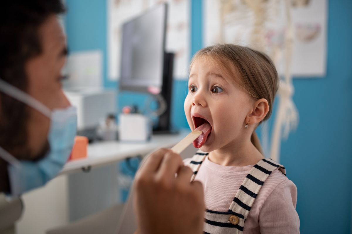 What Causes Bad Breath in Children? A pediatric dentist examines a young child during a routine dental checkup to identify possible oral health issues.