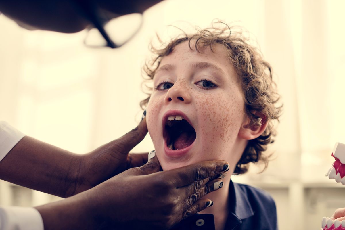 what-causes-bad-breath-in-children-lawrence-ny Parent learning what causes bad breath in children and when to seek pediatric dental care