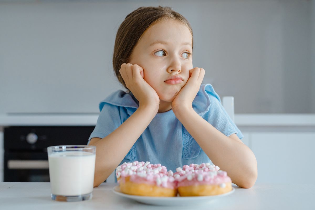 Child experiencing tooth sensitivity from sweets and other foods